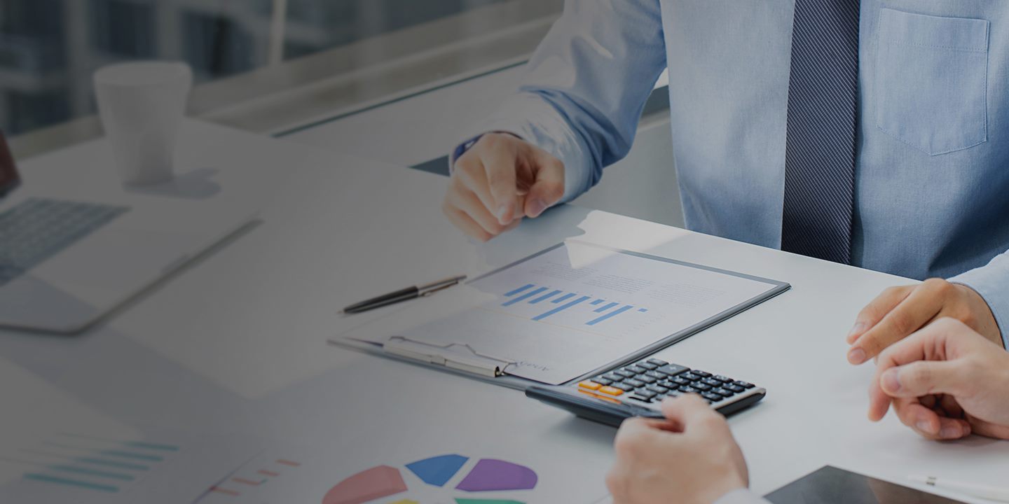 business people having a meeting looking at graphs on the table