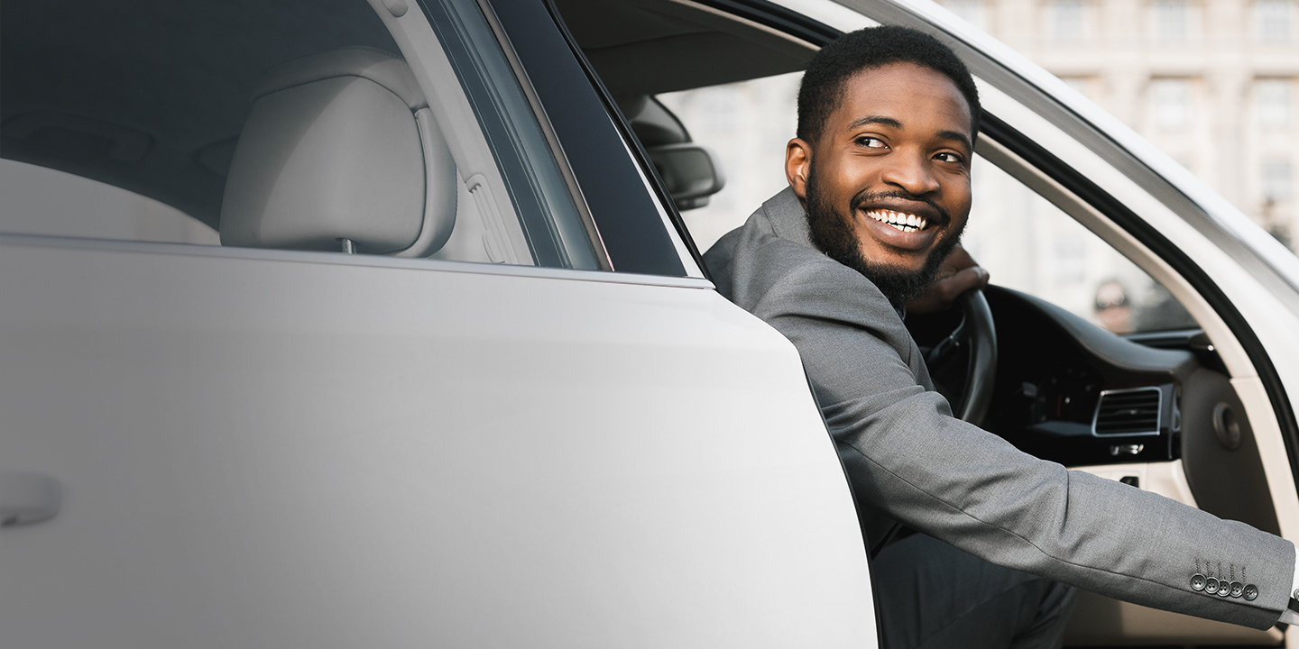 guy in his car smiling at the camera