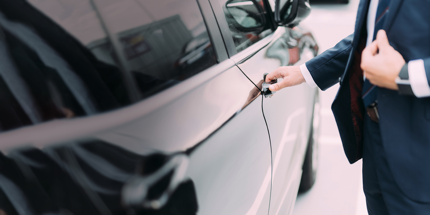 business man opening a car door