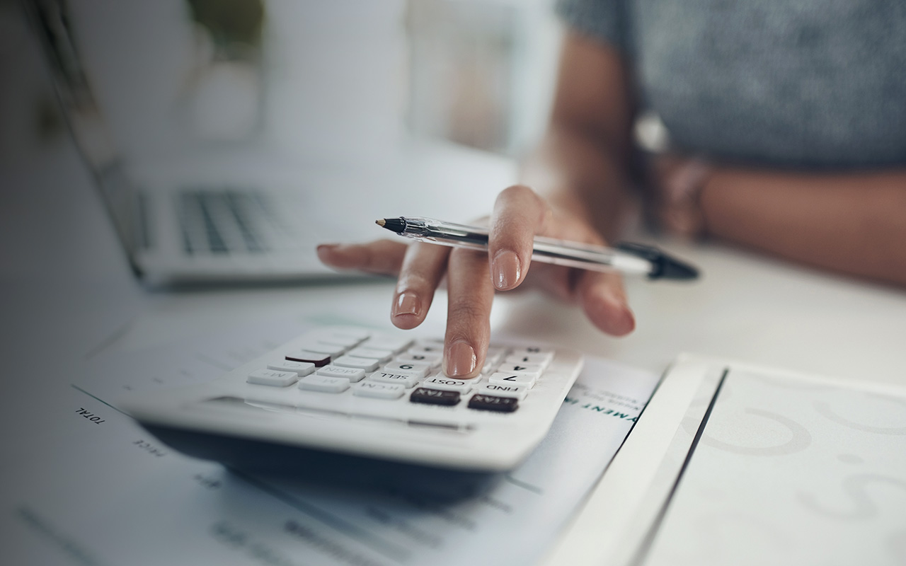 Woman in finance planning using a calculator