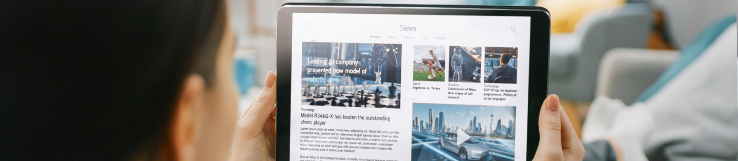 a women reading news on her tablet