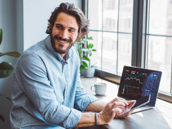 a guy scrolling on his phone smiling
