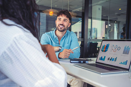 two people having a business meeting smiling