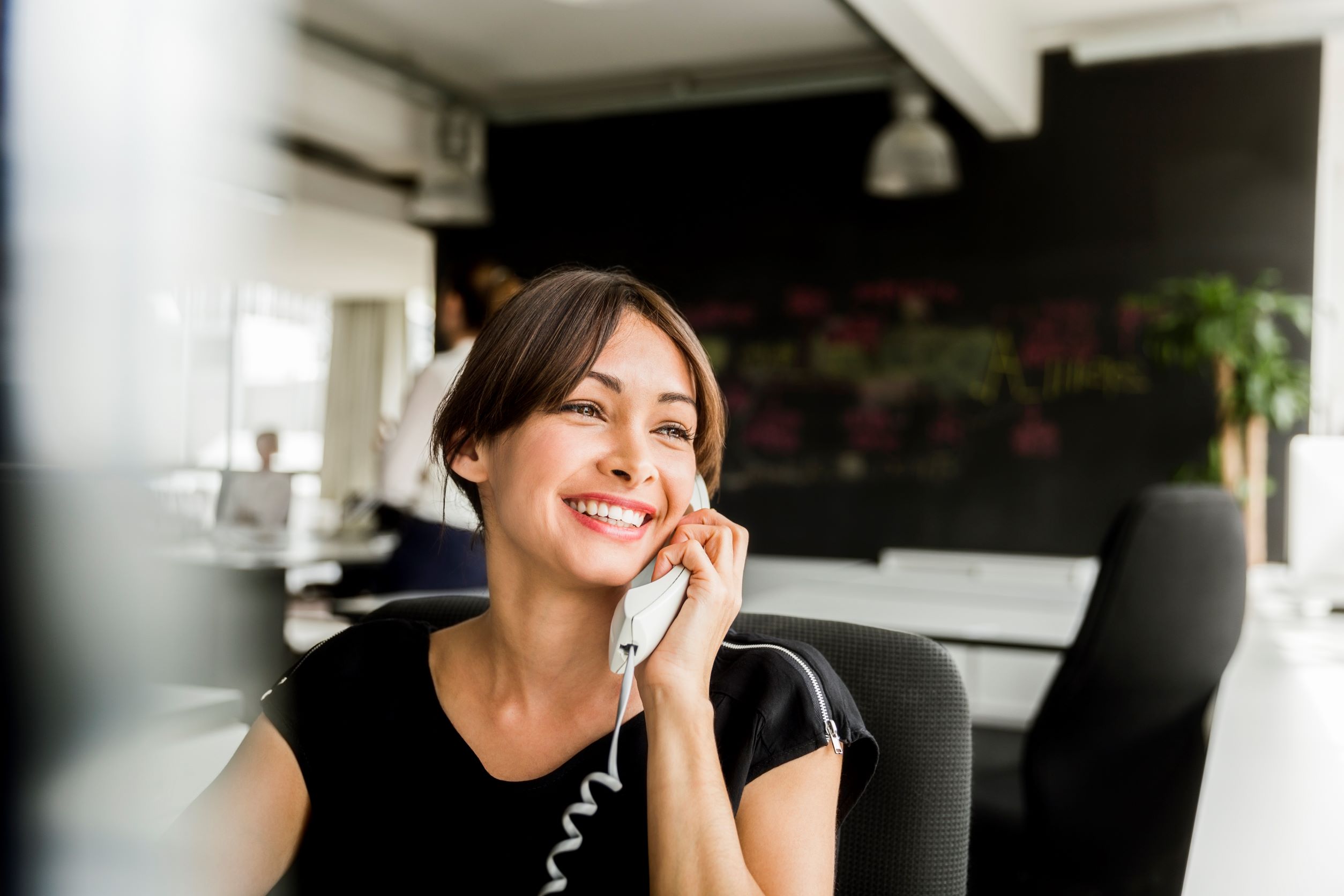 women on the phone smiling