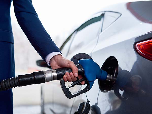 guy putting fuel in his car