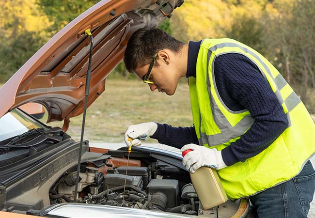 roadside assistance mechanic fixing an engine