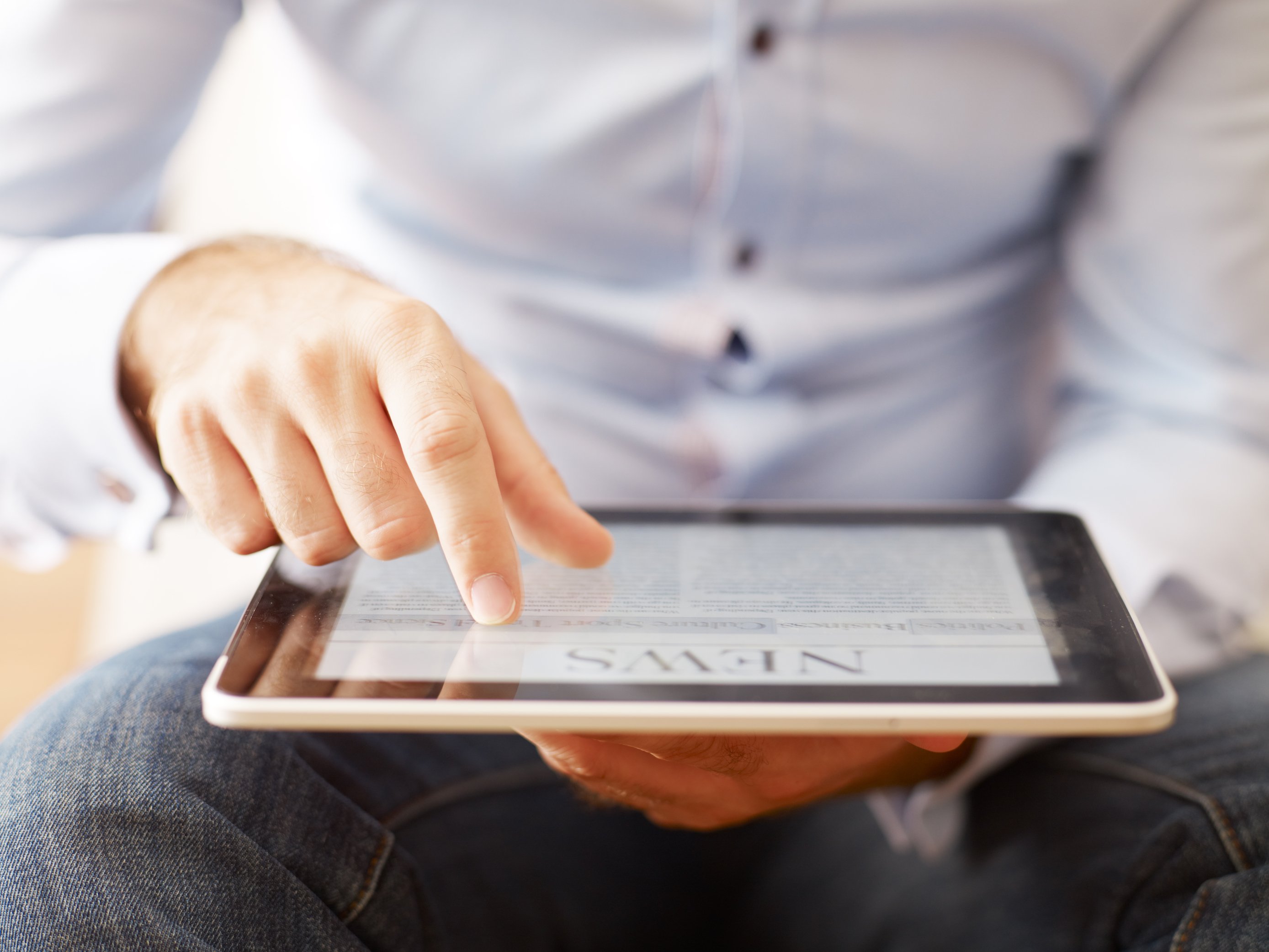 a guy scrolling on his ipad