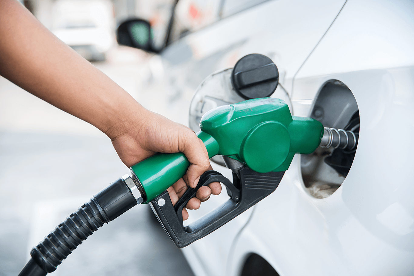 a person filling up a car with fuel