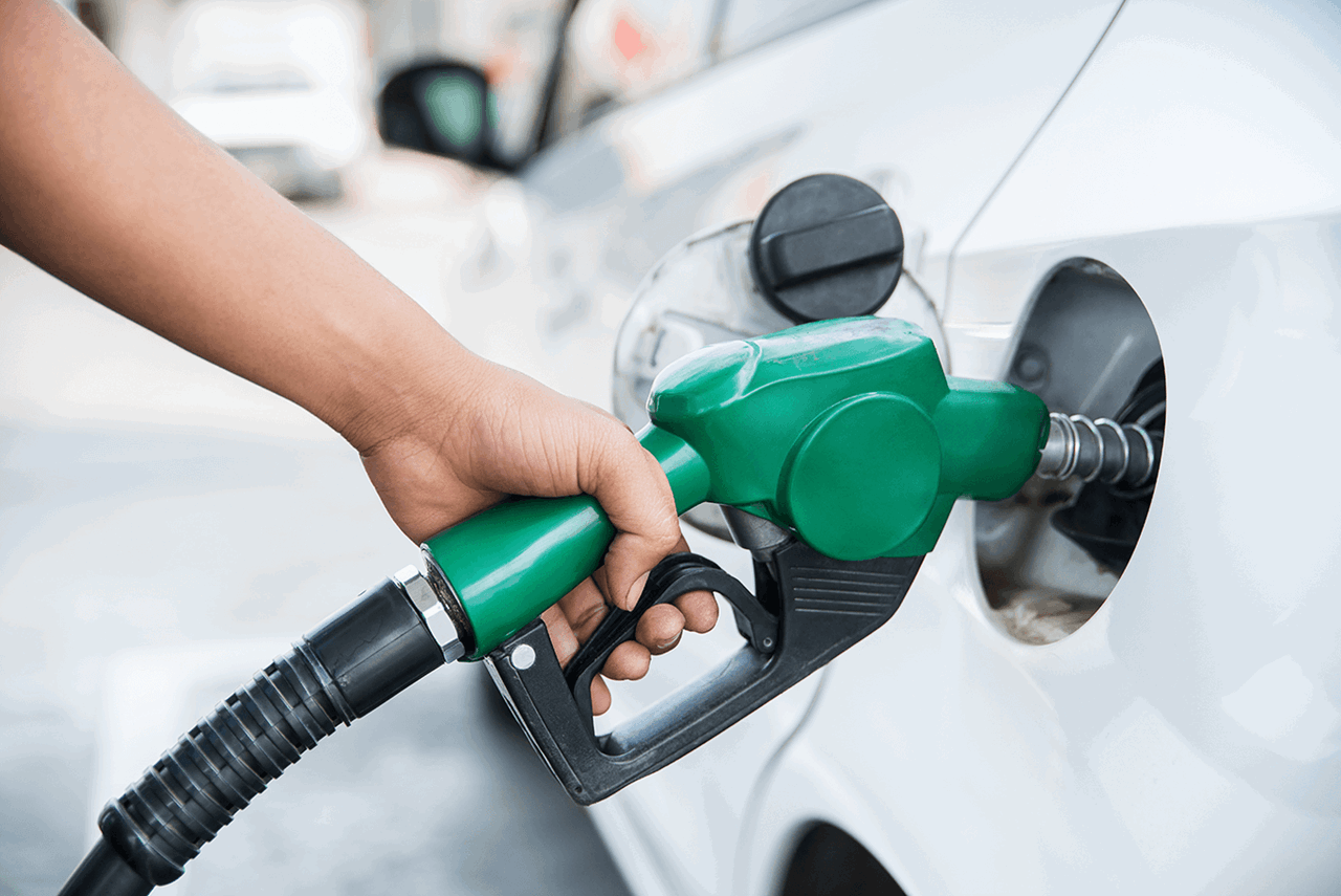 a person filling up a car with fuel