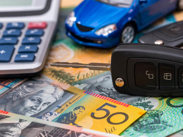 money, car keys and a calculator on a table