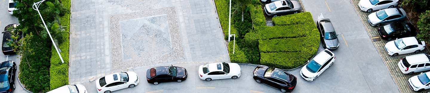 a top view of cars lined up in a parking lot