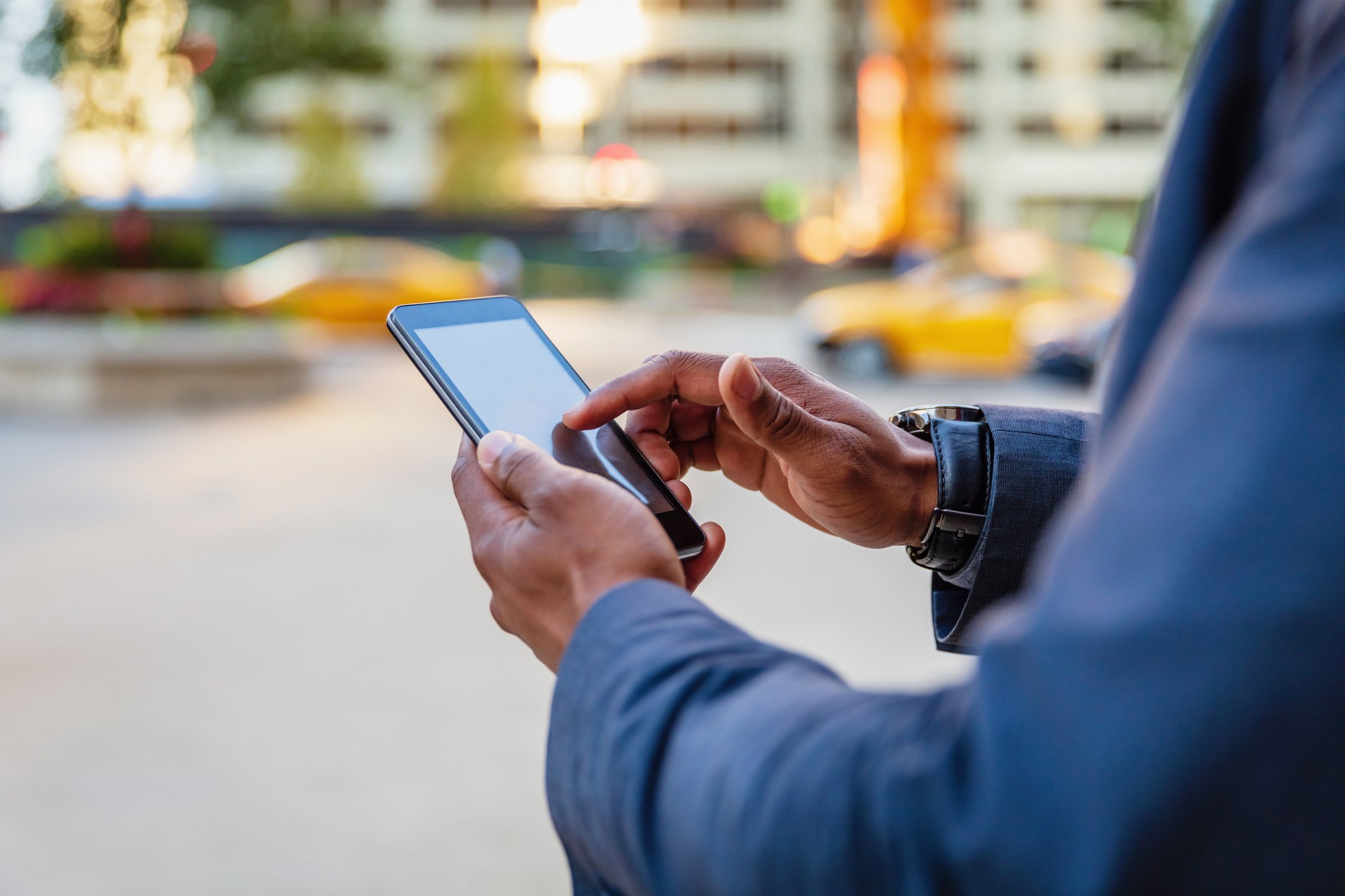 a guy scrolling on his smart phone