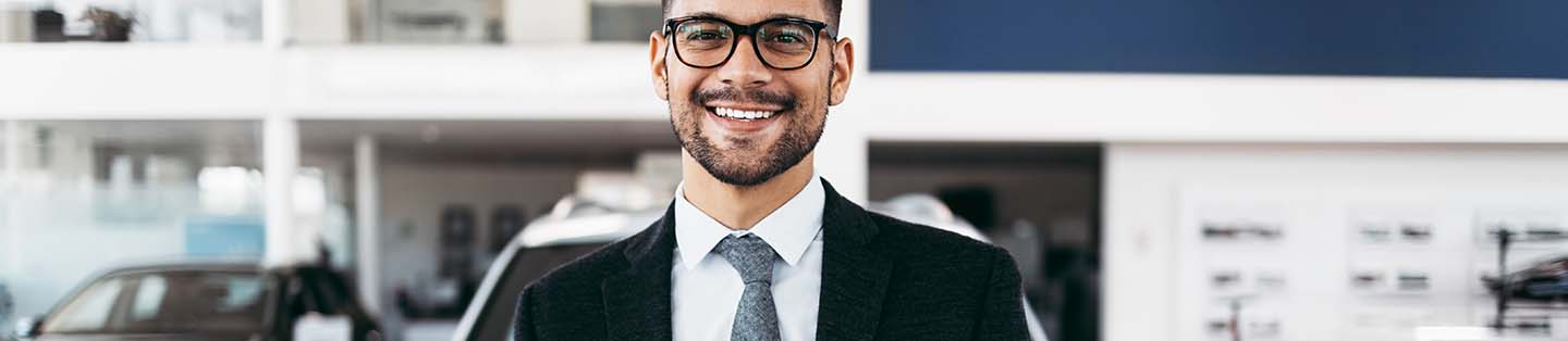 a businessman standing and smiling